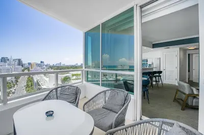 an apartment with a balcony with a table and chairs at FontaineBleau Suite Ocean View in Miami Beach