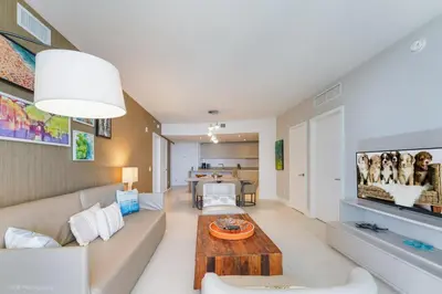 a living room with a couch and a table at LYFE Resort Ocean View Penthouse in Hollywood