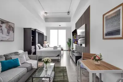 a living room with a couch and a bed at Cozy Studio in Brickell free parking in Miami