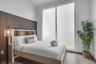 a bedroom with a bed and a large window at Cozy Studio in Brickell free parking in Miami
