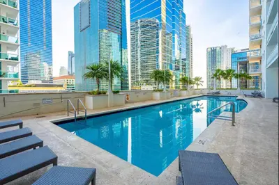 a swimming pool on the roof of a building with tall buildings at Cozy Studio in Brickell free parking in Miami