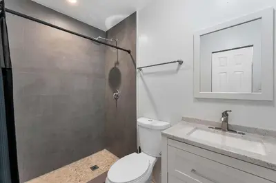 a bathroom with a shower and a toilet and a sink at Modern 3 BR Villa Near Beach & FLL in Hollywood
