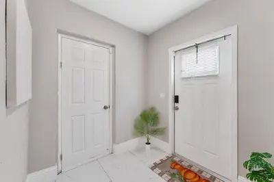 a white hallway with a white door and a plant at Modern 3 BR Villa Near Beach & FLL in Hollywood