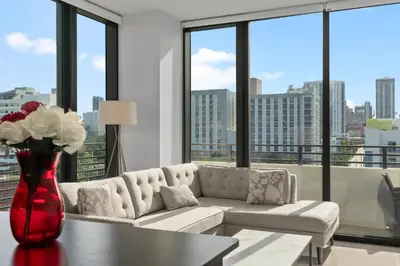 a living room with a couch and a vase with flowers at Luxury Pent House Suite with Downtown Views in Miami