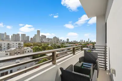 a balcony with two chairs and a view of the city at Luxury Pent House Suite with Downtown Views in Miami
