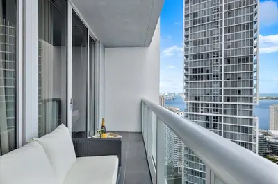 an apartment balcony with a view of the city at W hotel High end ocean view 2 bedroom at icon brickell in Miami