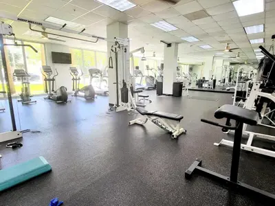 a gym with several treadmills and machines on the floor at Luxury Beach & City View Condo 5 min walk to beach in Sunny Isles Beach