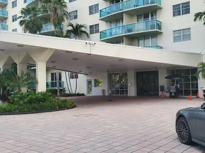 a car parked in front of a building at Luxury Beach & City View Condo 5 min walk to beach in Sunny Isles Beach