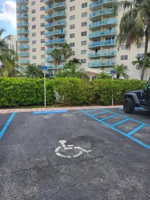 a parking lot with a bike painted on it at Luxury Beach & City View Condo 5 min walk to beach in Sunny Isles Beach