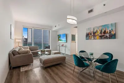 a living room with a couch and a table and chairs at 47th-Floor Brickell Condo with City Views and Pool in Miami