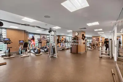 a gym with several people working out in the gym at 47th-Floor Brickell Condo with City Views and Pool in Miami