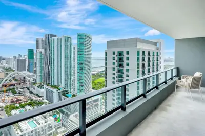 a balcony with a view of a city at 40th floor lux condo with pool, gym and spa access in Miami