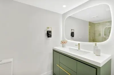 a bathroom with a sink and a mirror at Stylish Renovated 3BR Condo Bay Views plus Parking in Miami