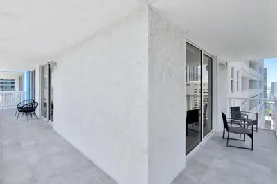 a white room with chairs and tables and windows at Stylish Renovated 3BR Condo Bay Views plus Parking in Miami