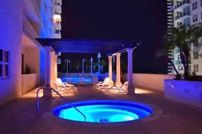 a hot tub in the middle of a patio at night at Stylish Renovated 3BR Condo Bay Views plus Parking in Miami
