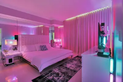 a bedroom with a white bed and pink lighting at Icon Brickell 20th Floor 1BR Pool View Balcony in Miami