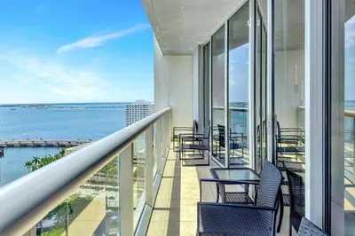a balcony with chairs and a view of the ocean at Icon Brickell 20th Floor 1BR Pool View Balcony in Miami