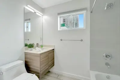 a bathroom with a shower and a toilet and a sink at Chic 2BR Edgewater Condo with Views plus Balcony in Miami