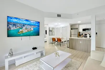 a living room with a white couch and a table at Chic 2BR Edgewater Condo with Views plus Balcony in Miami