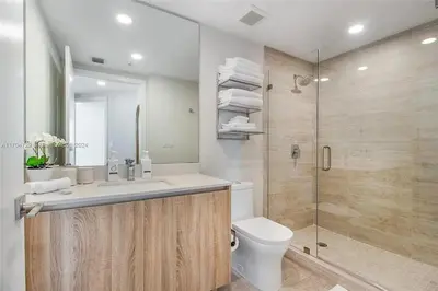 a bathroom with a shower and a sink and a toilet at Luxury Penthouse Water Views Massive Terrace in Miami
