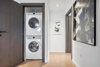 a laundry room with a washer and dryer in it at Top-floor 3BR Stay with skyline views in Miami