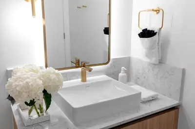 a bathroom with a sink and a vase of flowers at 2916 Heart of Downtown Apt with Gym a Pool and a Coworking Space in Miami