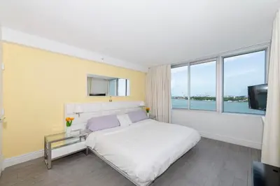 a bedroom with a white bed and a large window at 2 King Rooms Mondrian Resort Skyline Bay Balcony in Miami Beach