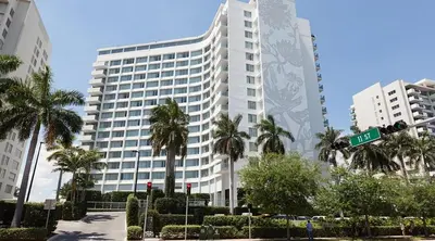 a large white building with palm trees in front of it at 2 King Rooms Mondrian Resort Skyline Bay Balcony in Miami Beach