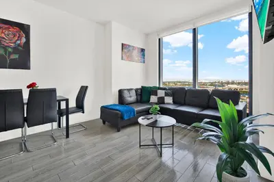 a living room with a couch and a table at Ocean Front Condo Near Cruise Port, Bayfront Park, plus Free Parking in Miami