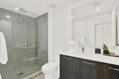 a bathroom with a shower and a toilet and a sink at Ocean Front Condo Near Cruise Port, Bayfront Park, plus Free Parking in Miami