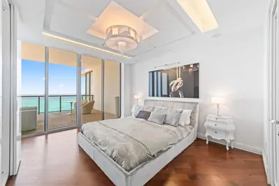 a bedroom with a large bed and a large window at Luxury 5 Stars - Oceanfront Stay for 4 with World-Class Amenities in Miami Beach