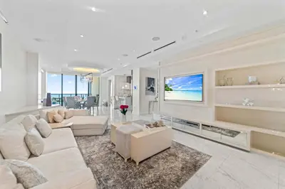 a living room with white furniture and a tv at Luxury 5 Stars - Oceanfront Stay for 4 with World-Class Amenities in Miami Beach