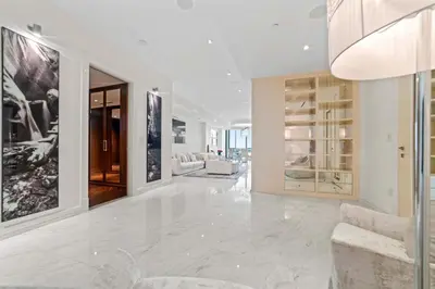 a white living room with a couch and a chair at Luxury 5 Stars - Oceanfront Stay for 4 with World-Class Amenities in Miami Beach