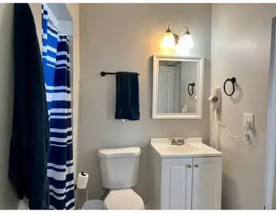 a bathroom with a toilet and a sink and a mirror at Studios & Coral Gable, close to downtown and airport in Miami