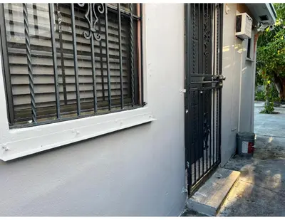 a window with a gate on the side of a building at Studios & Coral Gable, close to downtown and airport in Miami
