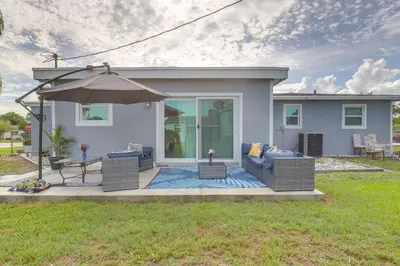 a house with a patio with a couch and an umbrella at Walk to 2026 FIFA World Cup! Home with Spacious Yard in Miami