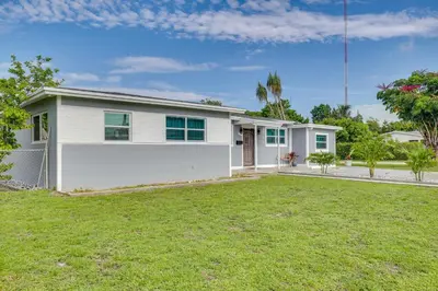a white house with a lawn in front of it at Walk to 2026 FIFA World Cup! Home with Spacious Yard in Miami