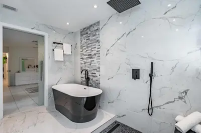 a white bathroom with a sink and a shower at Fox Island Heated Spa- Downtown & Beach in Fort Lauderdale