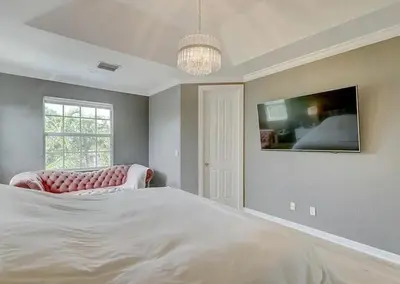 a bedroom with a large white bed and a window at Family house with Heated Pool, Walk to Dining in Fort Lauderdale