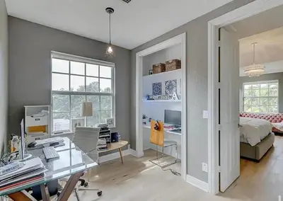 a bedroom with a bed and a desk with a computer at Family house with Heated Pool, Walk to Dining in Fort Lauderdale