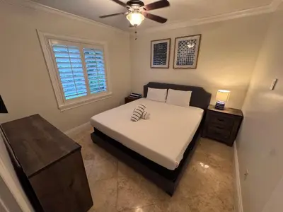 a bedroom with a bed and a ceiling fan at Casa Fina Miami Near Beaches