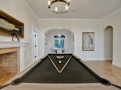 a pool table in a living room with a fireplace at Casa Fina Miami Near Beaches