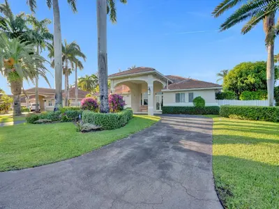 a house with palm trees and a driveway at Casa Fina Miami Near Beaches