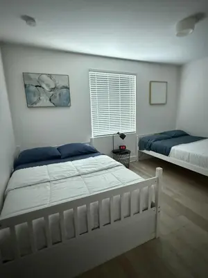 a bedroom with two beds and a window at Stylish Miami Getaway in Miami