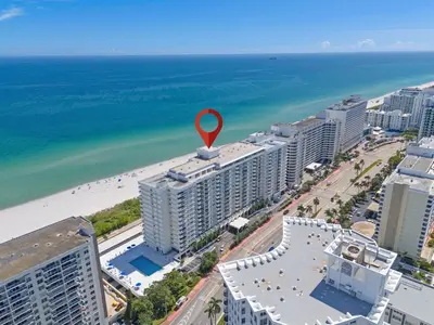 an aerial view of a beach with a red marker on a building at Elara Beachfront 2 Bedrooms Direct OceanView with Parking in Miami Beach