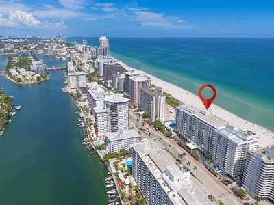 an aerial view of a city with a red marker on a beach at Elara Beachfront 2 Bedrooms Direct OceanView with Parking in Miami Beach