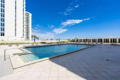 a swimming pool in the middle of a building at Elara Beachfront 2 Bedrooms Direct OceanView with Parking in Miami Beach