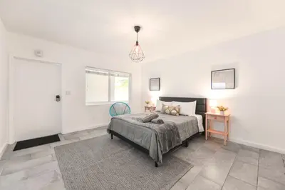 a white bedroom with a bed and a window at Coastal Studio Stay Near the Beach in Miami