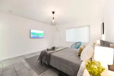 a bedroom with a bed and a couch at Coastal Studio Stay Near the Beach in Miami