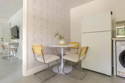 a kitchen with a table and chairs and a refrigerator at Your Modern South Florida Oasis Comfy and Central in Fort Lauderdale